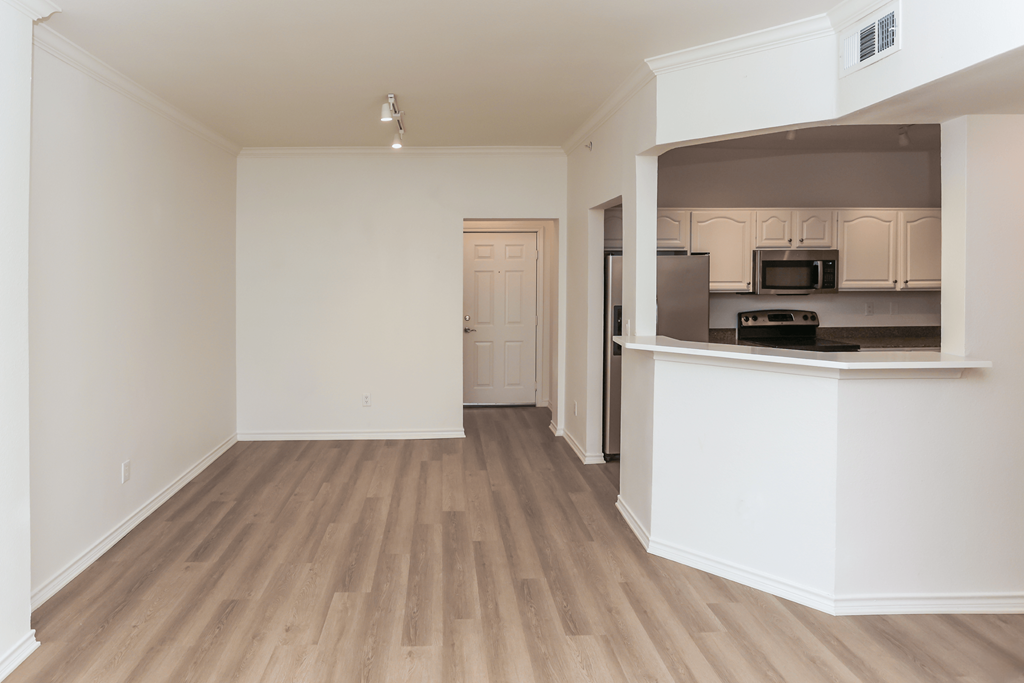 A kitchen area with a countertop and cabinets.